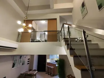 a hallway with a staircase in a house at A2J Luxury 3BR Suite Near Uptown Mall BGC Taguig in Manila
