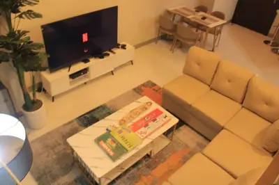 a living room with a couch and a tv at A2J Luxury 3BR Suite Near Uptown Mall BGC Taguig in Manila