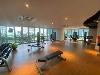 a gym with several treadmills and exercise equipment in a building at A2J Luxury 3BR Suite Near Uptown Mall BGC Taguig in Manila