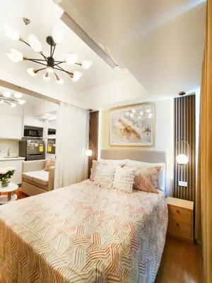 a bedroom with a bed and a living room at The Bahama Hammock - Azure PH in Manila