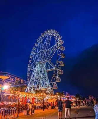 a large ferris wheel at a carnival at night at SHELL RESIDENCE c12 NEAR AIRPORT SHORWALK TO MALL OF ASIA in Manila