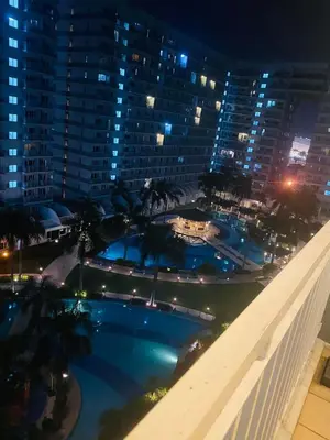 a view of a swimming pool at night at SHELL RESIDENCE c12 NEAR AIRPORT SHORWALK TO MALL OF ASIA in Manila