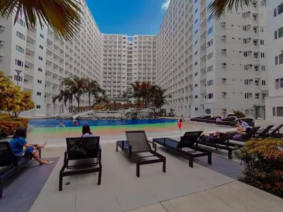 a group of people sitting in chairs in front of a pool at SHELL RESIDENCE c12 NEAR AIRPORT SHORWALK TO MALL OF ASIA in Manila