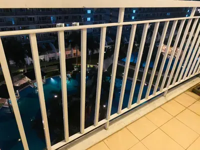 a balcony with a view of the city at night at SHELL RESIDENCE c11 SHORWALK MALL OF ASIA & AIRPORT in Manila
