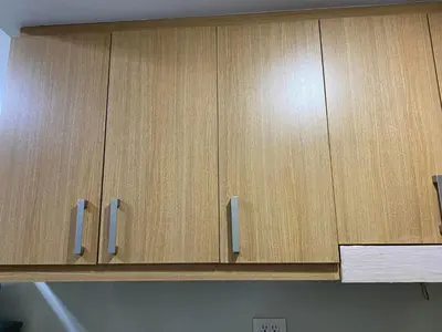 a wooden cabinet with silver handles in a kitchen at SHELL RESIDENCE C10 SHORWALK TO MALL OF ASIA NEAR AIRPORT in Manila