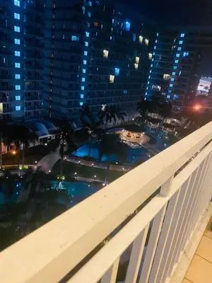a view from the balcony of a building at night at SHELL RESIDENCE C10 SHORWALK TO MALL OF ASIA NEAR AIRPORT in Manila