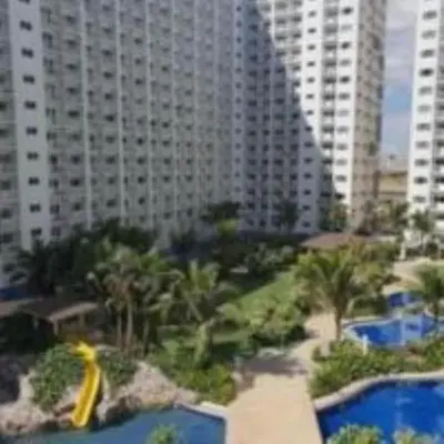 a view of a resort with palm trees and buildings at SHORE RESIDENCE D8 NEAR aiRPORT & SHORTWALK TO MALL OF ASIA in Manila