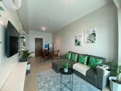 a living room with a couch and a table at Family size Staycation in Makati with new year's firework balcony view in Manila