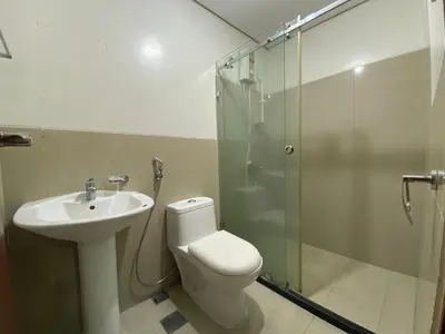 a bathroom with a toilet and a sink and a shower at Family size Staycation in Makati with new year's firework balcony view in Manila