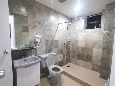 a bathroom with a toilet and a sink and a shower at Accommodation services in Manila