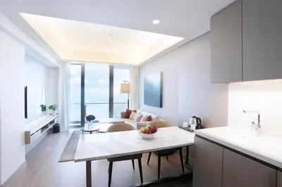 a kitchen and living room with a table and a couch at Lanson Place Mall of Asia Manila in Manila
