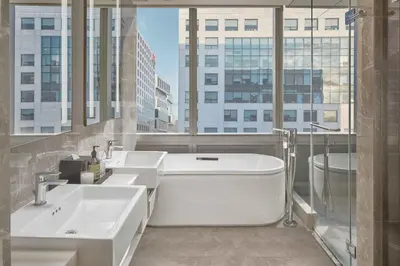 a bathroom with two sinks and a bath tub at Lanson Place Mall of Asia Manila in Manila