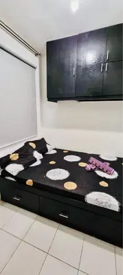 a bed in a room with a black and white at 2 BR staycation beside Enchanted Kingdom in Santa Rosa
