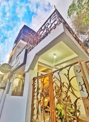 a house with a gate in front of it at NomadsMNL Airport Hostel in Manila