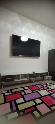 a room with a flat screen tv on the wall at Shore Residence Tower C2 in Manila