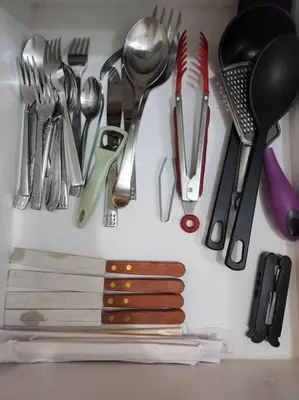 a bunch of utensils are hanging on a wall at Casa Antonio at Viceroy McKinley Hill in Manila