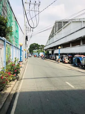 an empty street with cars parked on the side of a building at THE MANSION: 18 PAX BUDGET NEAR AIRPORT TERMINAL PASAY in Manila