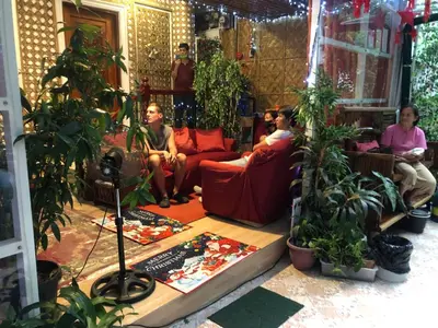 a group of people sitting in a living room with plants at THE MANSION: 18 PAX BUDGET NEAR AIRPORT TERMINAL PASAY in Manila
