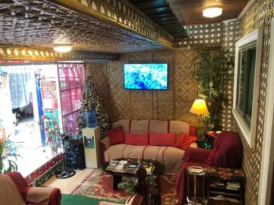 a living room with a couch and a tv at THE MANSION: 18 PAX BUDGET NEAR AIRPORT TERMINAL PASAY in Manila
