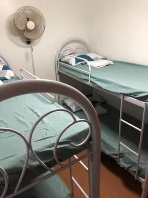 a hospital room with two bunk beds and a fan at THE MANSION: FAMILY AND BARKADA BONDING PLACE IN PASAY NEAR AIRPORT in Manila