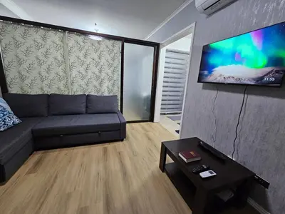 a living room with a couch and a flat screen tv at South of Market Private Residence in Manila