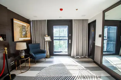 a living room with a blue chair and a window at ASN Boutique Residence in Manila