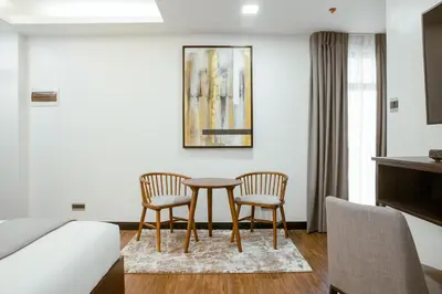 a hotel room with a table and two chairs at ASN Boutique Residence in Manila
