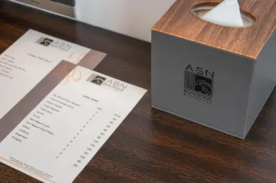 a wooden table with a box and some receipts at ASN Boutique Residence in Manila