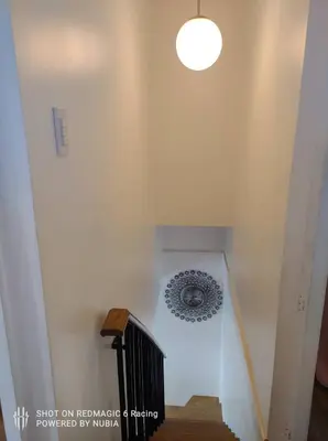a stairway with a light fixture and a stair case at Fort Victoria Condominium Tower C in Manila