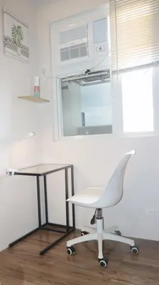 a white chair and a table in a room at CONDOMINIUM AT TAFT AVENUE, MALATE, Manila in Manila