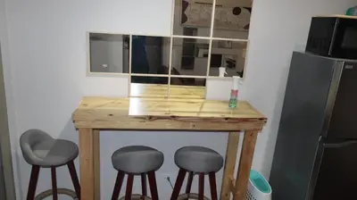 a small table with two stools and a microwave at CONDOMINIUM AT TAFT AVENUE, MALATE, Manila in Manila