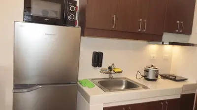 a kitchen with a stainless steel refrigerator and a sink at CONDOMINIUM AT TAFT AVENUE, MALATE, Manila in Manila