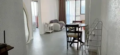 a living room with a table and a chair at Comfort room in Manila
