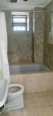 a bathroom with a toilet and a bath tub at Comfort room in Manila