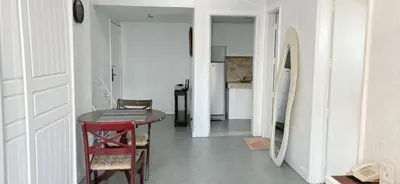 a room with a table and chairs and a kitchen at Comfort room in Manila