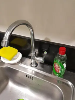 a sink with a bottle of detergent next to it at Jamaica's Place 1br Amenities View at Shell Residences in Manila