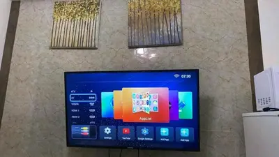 a flat screen tv hanging on a wall at CHATEAU ELYSEE a7 near Airport and Sm mall in Manila