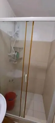 a shower with a glass door in a bathroom at CHATEAU ELYSEE a8 near Airport and Sm mall, WIFI in Manila