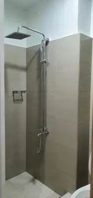 a shower with a glass door in a bathroom at Shore 2 residences condominium in Manila