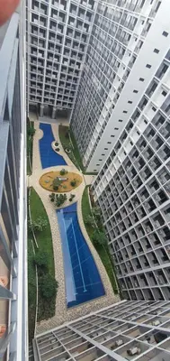 an aerial view of a large building with a swimming pool at Shore 2 residences condominium in Manila