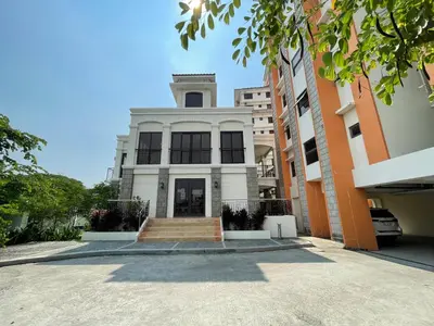 a white building with a staircase in front of it at Hannah’s Morning Sun - Studio Room in Manila