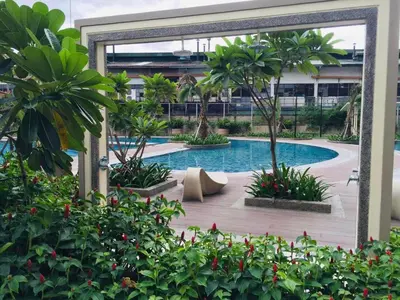 a pool in a building with trees and plants at TresMariasCrib 3BR Unit at Pasig City Philippines in Manila
