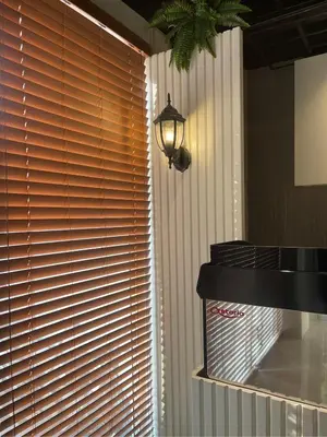 a window with wooden blinds on it with a light at Airo Suites Makati in Manila