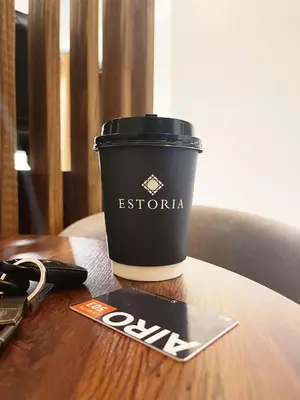 a cup of coffee sitting on a wooden table at Airo Suites Makati in Manila