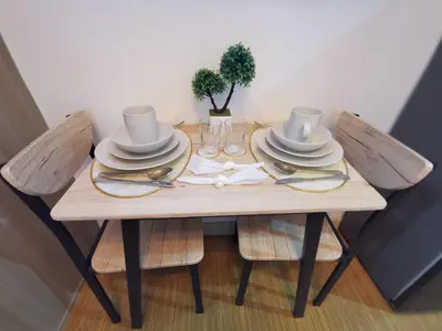 a wooden table with hats and plates on it at Nathan's Pad @ Grace residences Nr. BGC in Manila