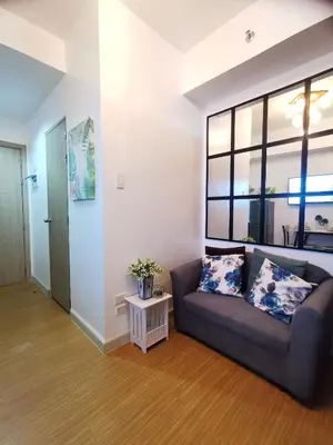 a living room with a couch and a window at Nathan's Pad @ Grace residences Nr. BGC in Manila