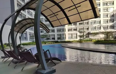 a group of chairs sitting in front of a building at Nathan's Pad @ Grace residences Nr. BGC in Manila