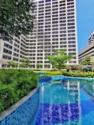 a swimming pool in front of a tall building at Nathan's Pad @ Grace residences Nr. BGC in Manila