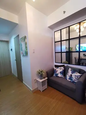 a living room with a couch and a table at Nathan's Pad @ Grace residences Nr. BGC in Manila