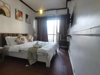 a bedroom with a bed with a teddy bear on it at Accommodation Service in Manila